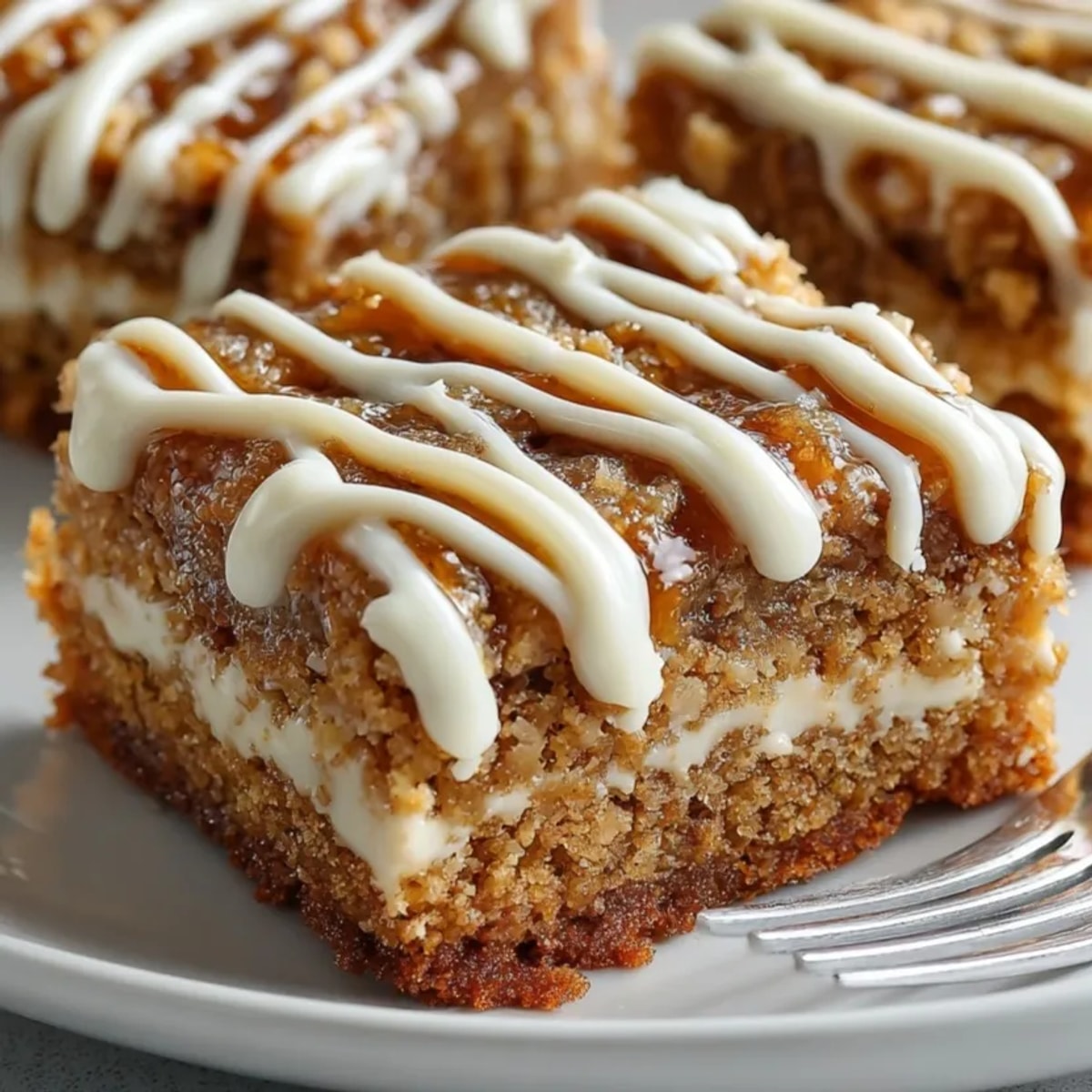 Warm, gooey Swedish Ginger Snap Cookie Bars topped with a creamy white chocolate drizzle and ready to serve.