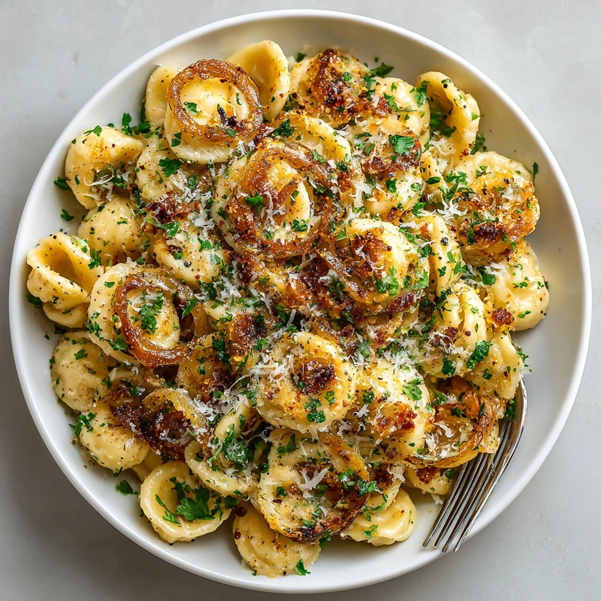Hearty Easy French Onion Pasta served hot in a bowl, featuring rich, golden onions and cheesy sauce