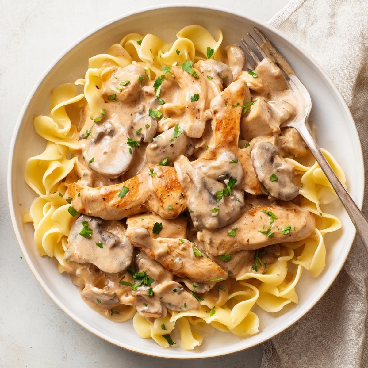 A comforting bowl of Creamy Chicken Stroganoff featuring tender chicken and rich sauce.  