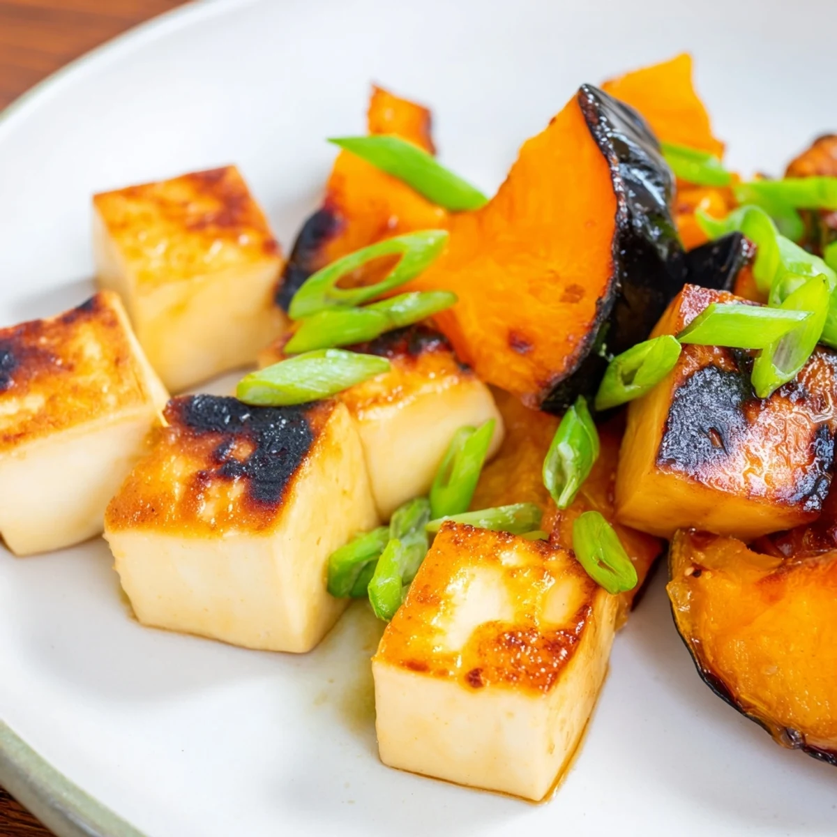Perfectly caramelized Miso-Glazed Tofu and squash, drizzled with savory miso sauce, ready for serving.