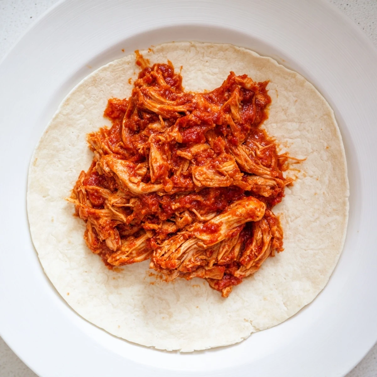 Crock-Pot Shredded Chicken Tacos spilling out from warm tortillas, ready for fresh toppings.