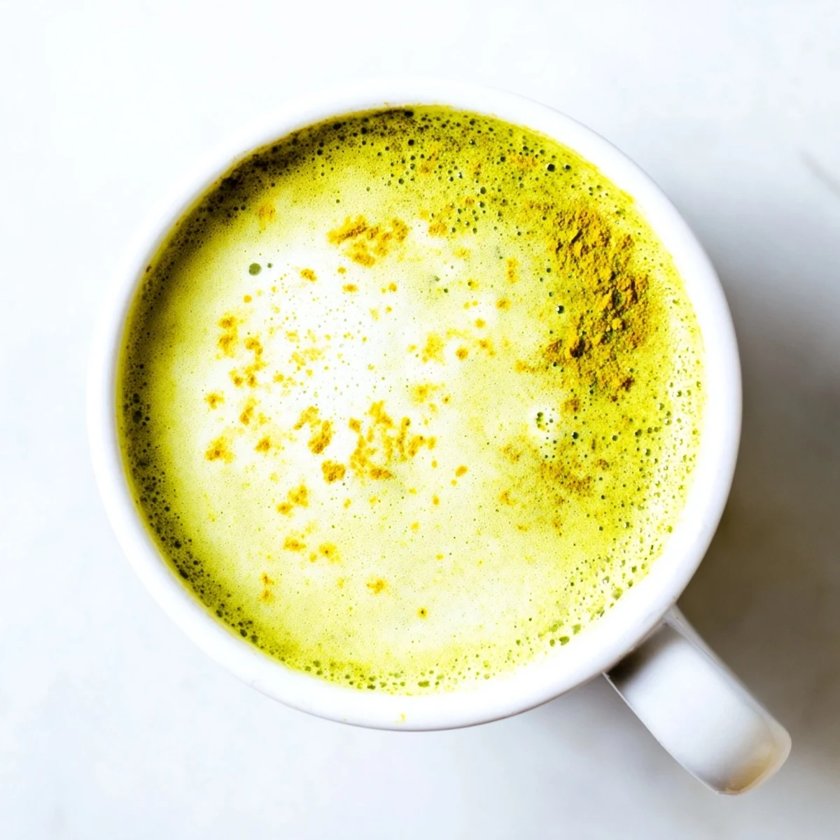 A creamy Coconut Ginger Matcha Winter Immunity Latte, perfect for a cozy afternoon and boosting immunity.
