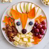 Beautifully arranged Whimsical Fox Fall Treat Board with a goat cheese fox head and colorful goodies, ready to serve.