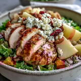 Golden roasted chicken and sweet potatoes top a hearty Harvest Bowl with kale, wild rice, and crunchy almonds.