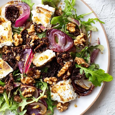 Spiced Honey and Date Goat Cheese Salad displays fresh greens and crumbled cheese, drizzled with sweet honey dressing.
