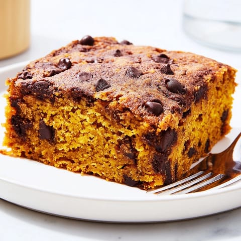 Warm, spiced Chocolate Pumpkin Chip Blondies fresh from the oven on a wire rack.
