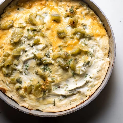 Gooey Dill Pickle Queso Fundido Dip, a tangy delight perfect for game day snacking.  