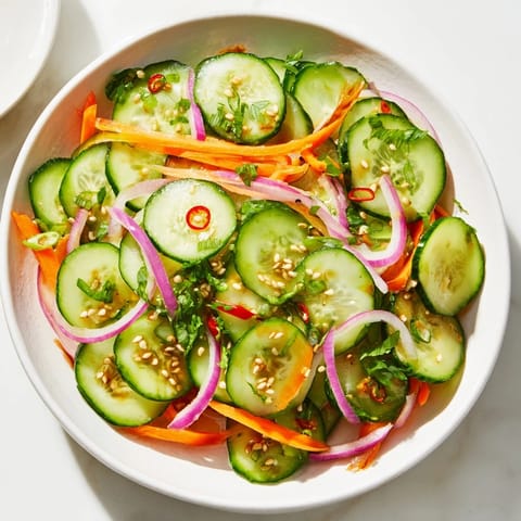 Light and zesty cucumber salad remix sprinkled with toasted sesame seeds, ready to serve.  