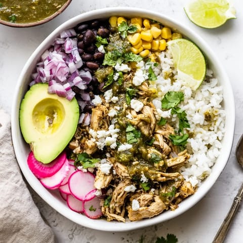 Zesty green enchiladas rice bowl featuring tender chicken and vibrant corn blend.  
