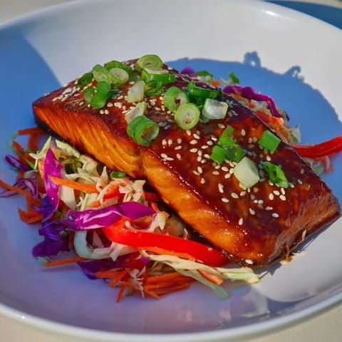 This teriyaki salmon and Asian slaw bowl presents a balanced, flavorful, and satisfying meal.