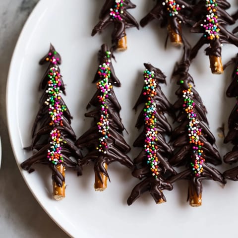 Homemade Express Chocolate Christmas Trees, perfect for holiday gifting, sitting on a parchment-lined baking sheet.