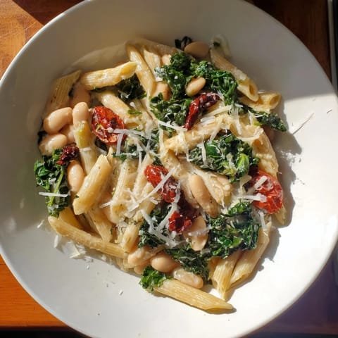 Creamy, flavorful bowl of Healthy Tuscan White Bean & Kale Christmas Pasta ready to enjoy.