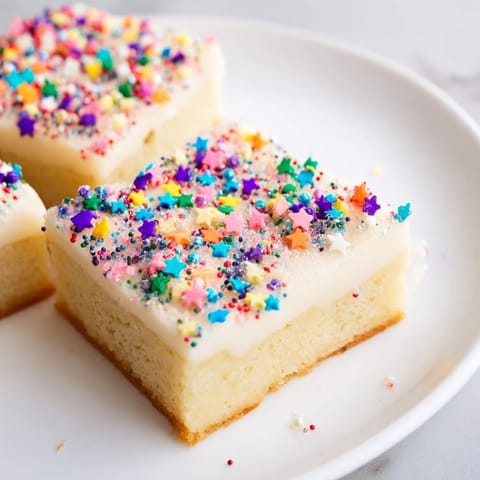 Golden-baked Twinkle Twinkle Star Dessert Bars, drizzled with vanilla frosting and twinkling star sprinkles.