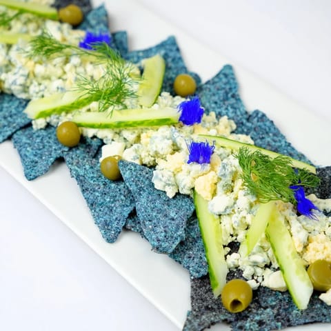 Freshly assembled Deep Sea Ocean Wave recipe, showcasing vibrant green grapes and crunchy chips, ready to serve.
