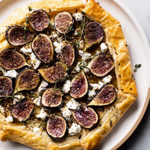 A close-up of a delightful puff pastry truffle pizza showcasing the vibrant, baked ingredients.
