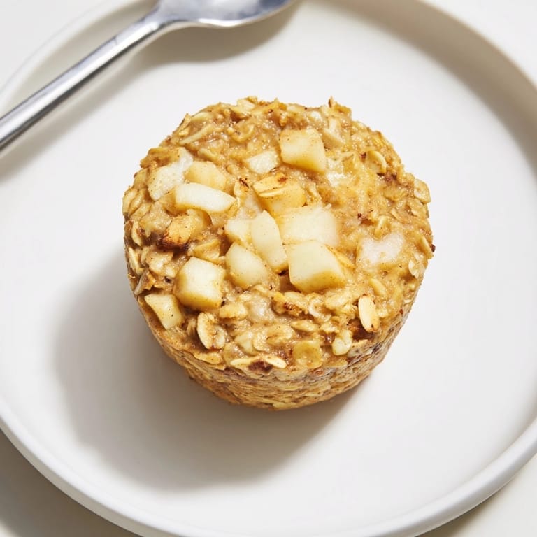 A batch of Protein Apple Cinnamon Oatmeal Cups, a healthy baked morning treat.