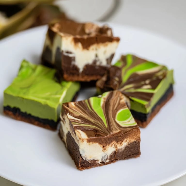 Creamy black sesame cheesecake bars with a crunchy cookie crust, a unique dessert choice.