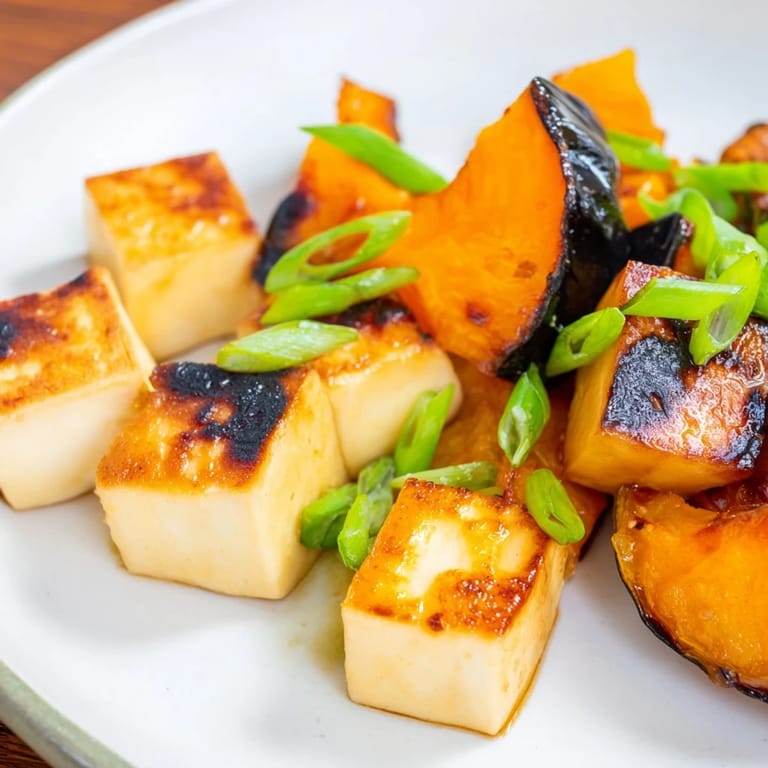 Perfectly caramelized Miso-Glazed Tofu and squash, drizzled with savory miso sauce, ready for serving.