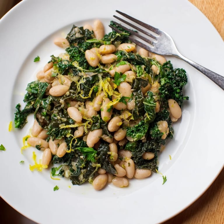 Rustic plate of Garlicky Beans with Winter Greens, a comforting vegetarian dish ready to be served.